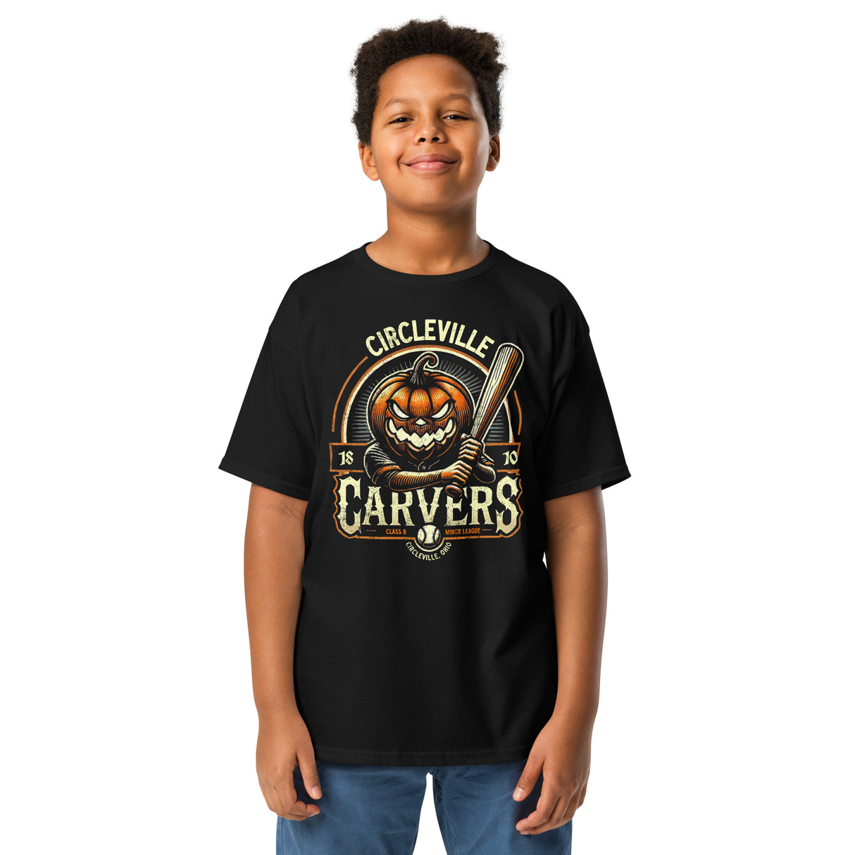 Young boy wearing black Circleville Carvers youth t-shirt with a retro Halloween baseball pumpkin mascot