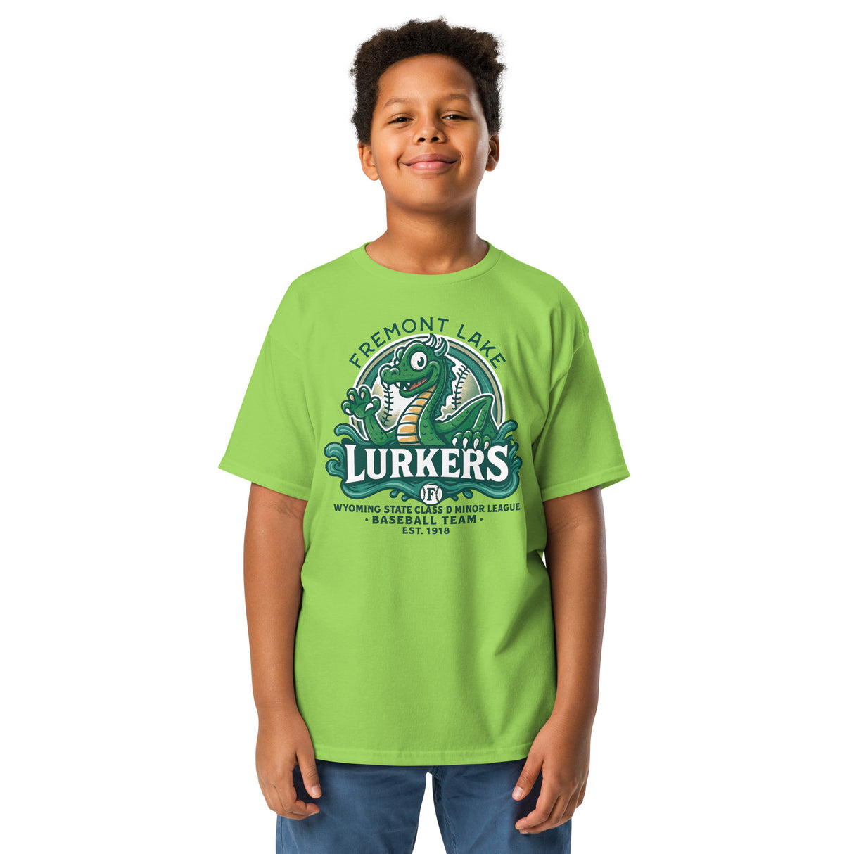 Young boy smiling while wearing a lime Fremont Lake Lurkers tee featuring a retro minor league-style Nessie mascot.