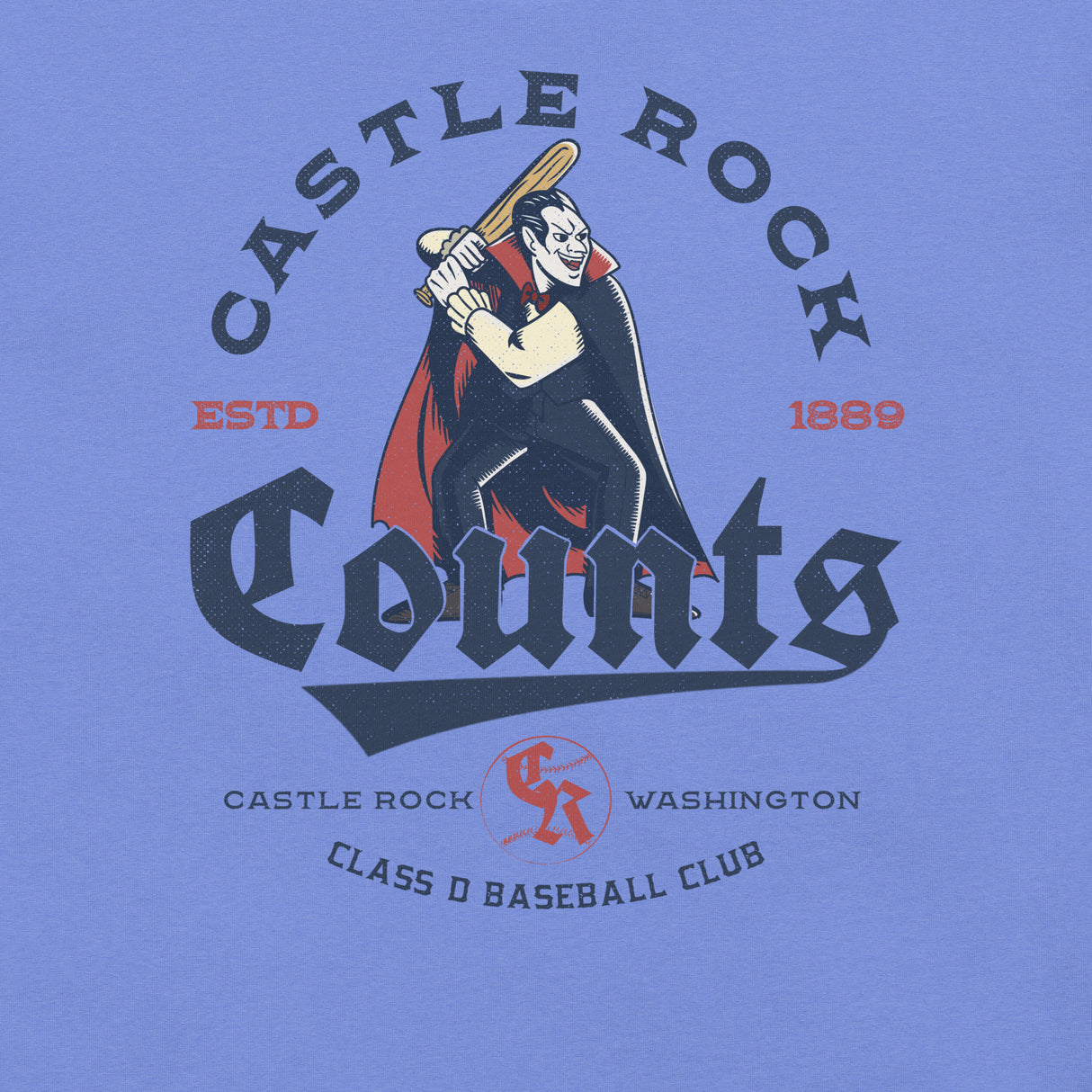 Detailed view of the Castle Rock Counts retro design on Heather Royal Blue shirt, highlighting the Dracula batter mascot.