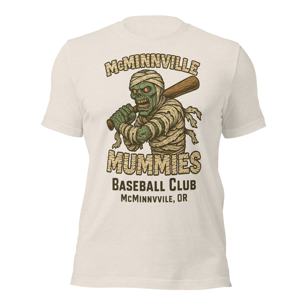 Flat lay of McMinnville Mummies vintage baseball tee in heather dust, featuring creepy mummy mascot and retro minor league style.
