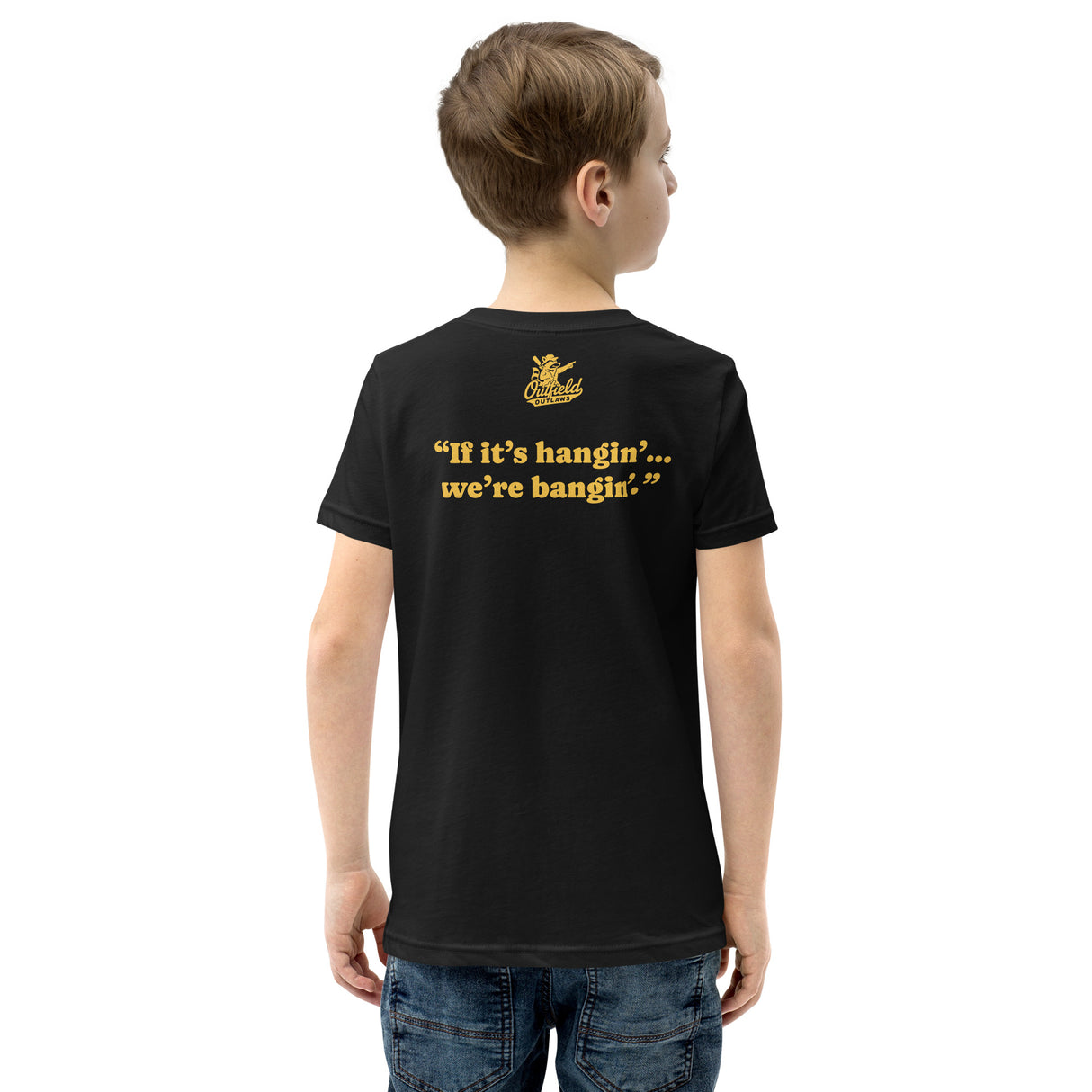 Young boy showing back of black Deep Ball Dumpers tee with Outfield Outlaws logo and slogan print.