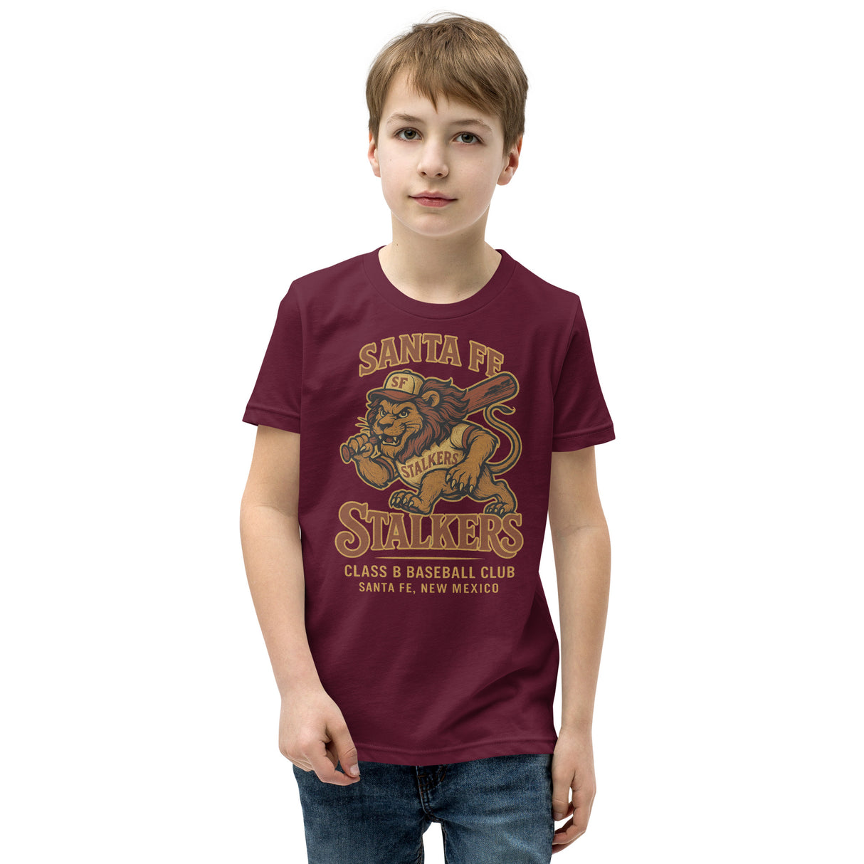 Youth boy model wearing Santa Fe Stalkers lion mascot baseball shirt in maroon Bella Canvas youth fit