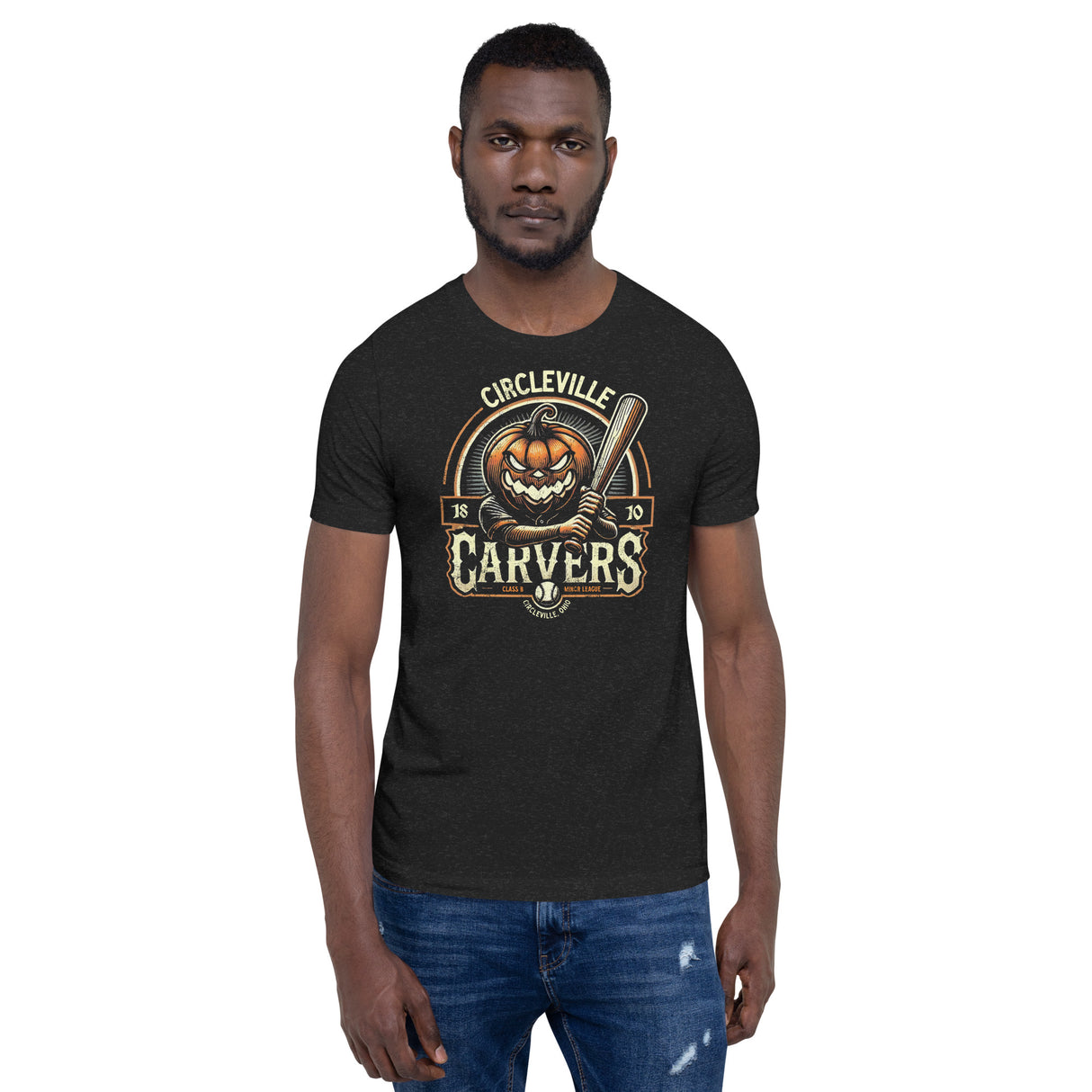 Man wearing heather black Circleville Carvers t-shirt featuring a vintage-style pumpkin-headed slugger mascot