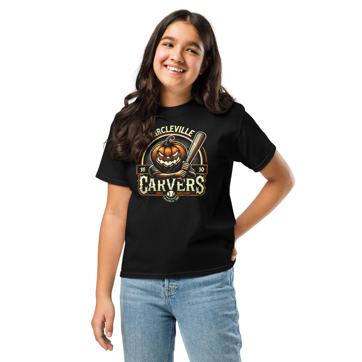 Young girl in black Circleville Carvers youth tee showing off vintage-style pumpkin baseball mascot