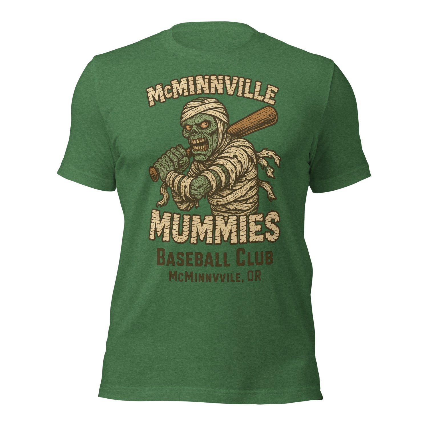 Flat lay of McMinnville Mummies retro baseball t-shirt in heather grass green, showcasing vintage mummy mascot and distressed design.