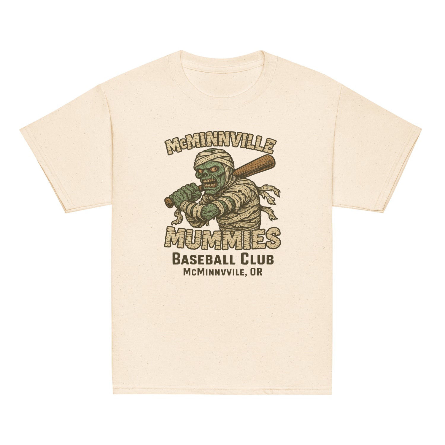Flat lay of McMinnville Mummies youth vintage baseball shirt in heather dust, showcasing retro mummy mascot and distressed team logo.