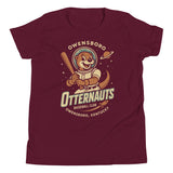 Flat lay of Owensboro Otternauts youth t-shirt in maroon with retro space otter mascot holding bat, Bella Canvas youth fit