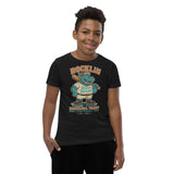 Youth boy model wearing Rocklin River Horses mascot shirt in black featuring baseball hippo design, Bella Canvas youth fit