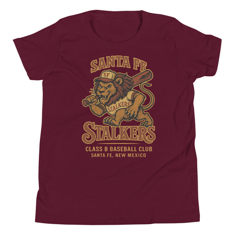 Flat lay of Santa Fe Stalkers youth t-shirt in maroon featuring fierce lion baseball mascot on Bella Canvas 3001Y